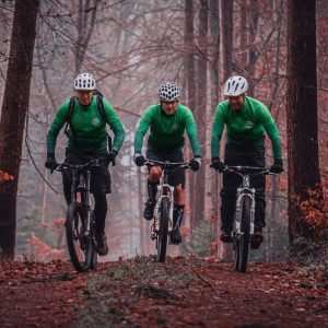 Team Greenbay Cycles riding in the woods wearing DOWE BasicForm Long-Sleeve Jerseys